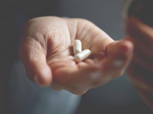 Is it took late? (picture of white person's hand with two white pills)